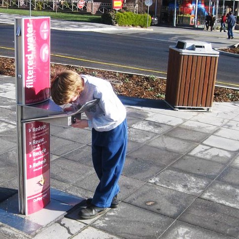 kid drinking at fountain